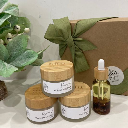A curated collection of 50ml sugar scrub, 50ml body custard, 50ml whipped body butter, and 30ml bath and body oil for a spa-like skincare experience at home.