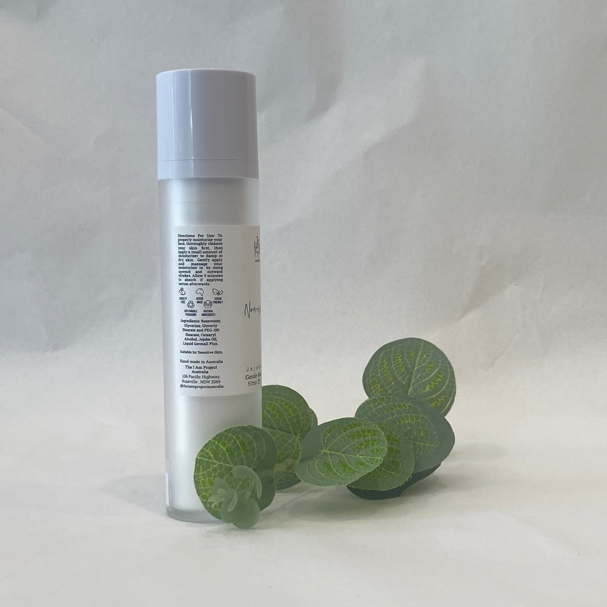 Skincare bottle with eucalyptus leaves on a white background