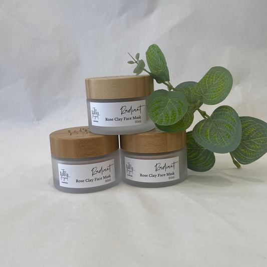 Three jars of aloe vera with a plant on a white background