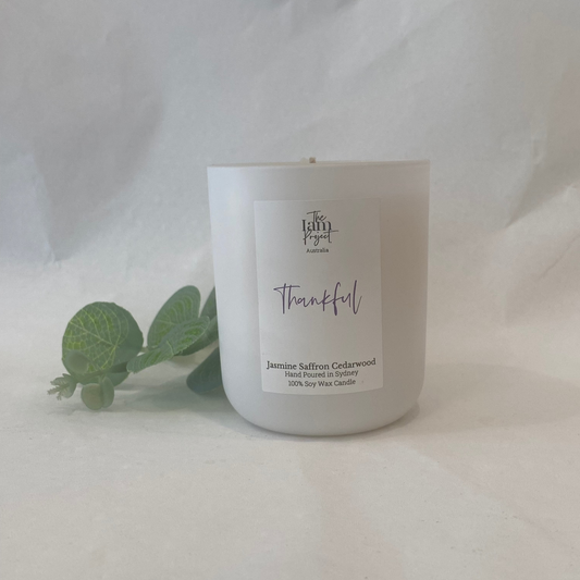 White candle with a label on a white background